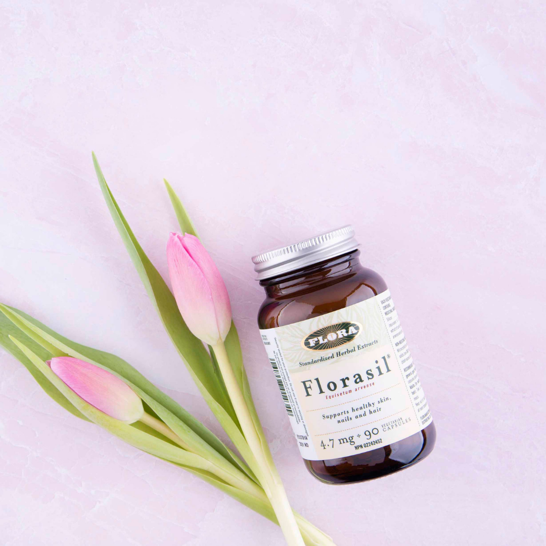 Florasil hair, skin and nail supplement capsules pictured with budding flowers