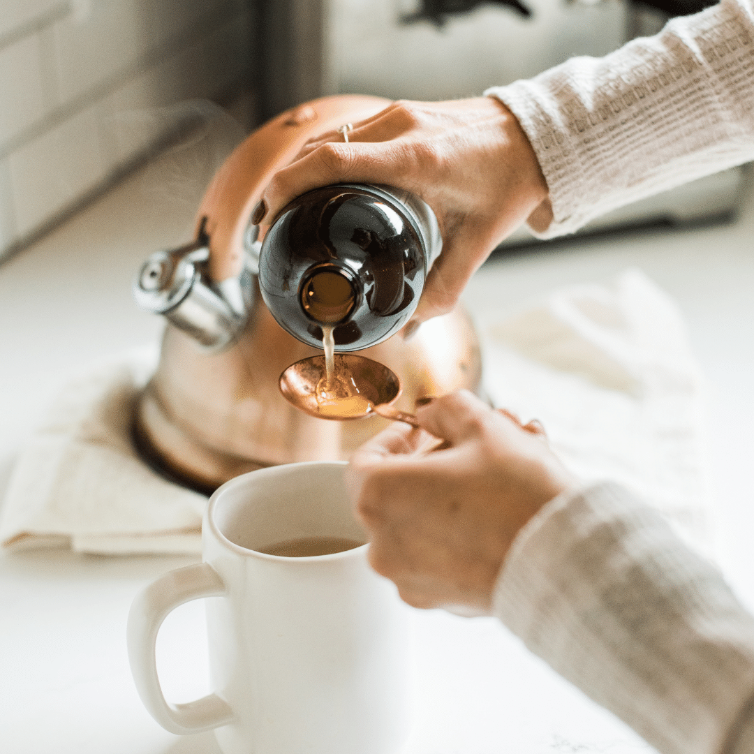 Flor*Essence immune system supplement being poured into teaspoon over tea mug