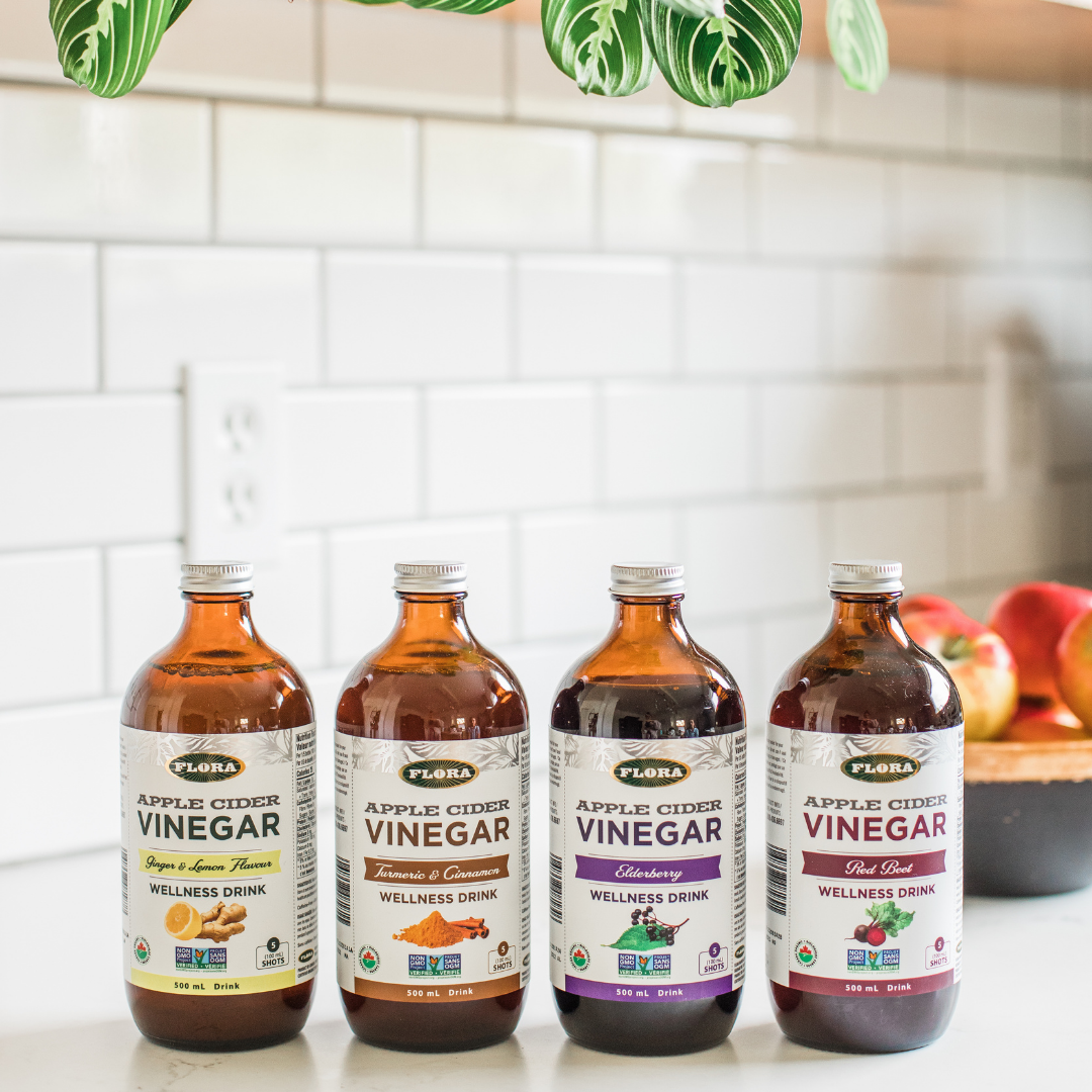 organic apple cider vinegar bottles in four flavors: lemon ginger, turmeric cinnamon, elderberry, and red beet